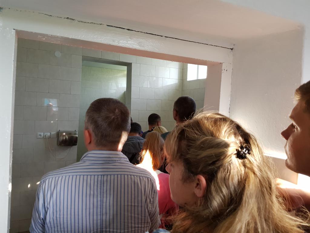 Ladies and gents in the same queue for washroom at border crossing from Lviv to Warsaw