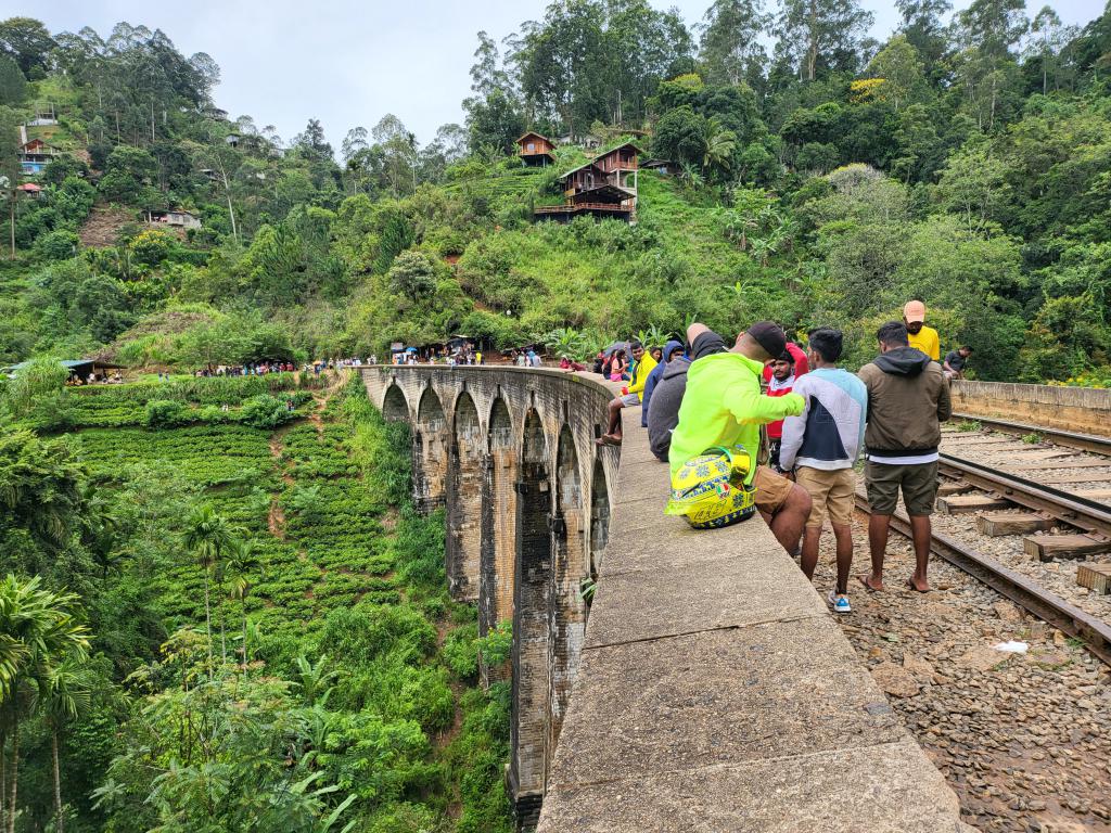 Visitors taking over the high Nine Arches Bridge