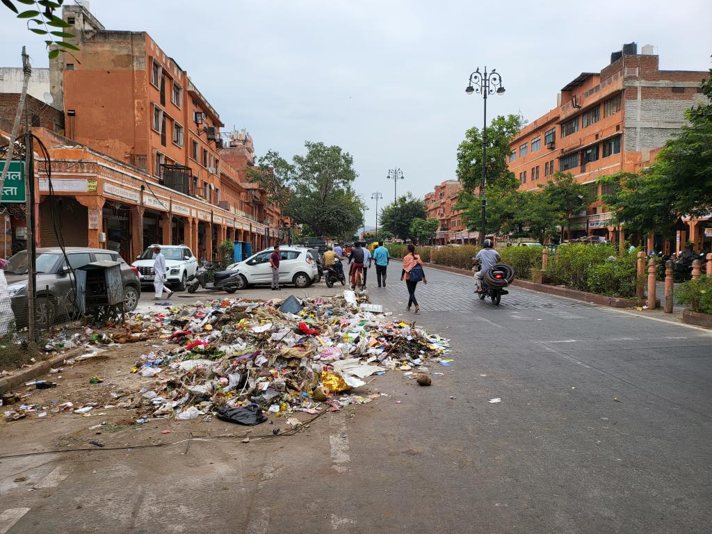 A big pile of rubbish on the busy shopping street in the city center. But why?