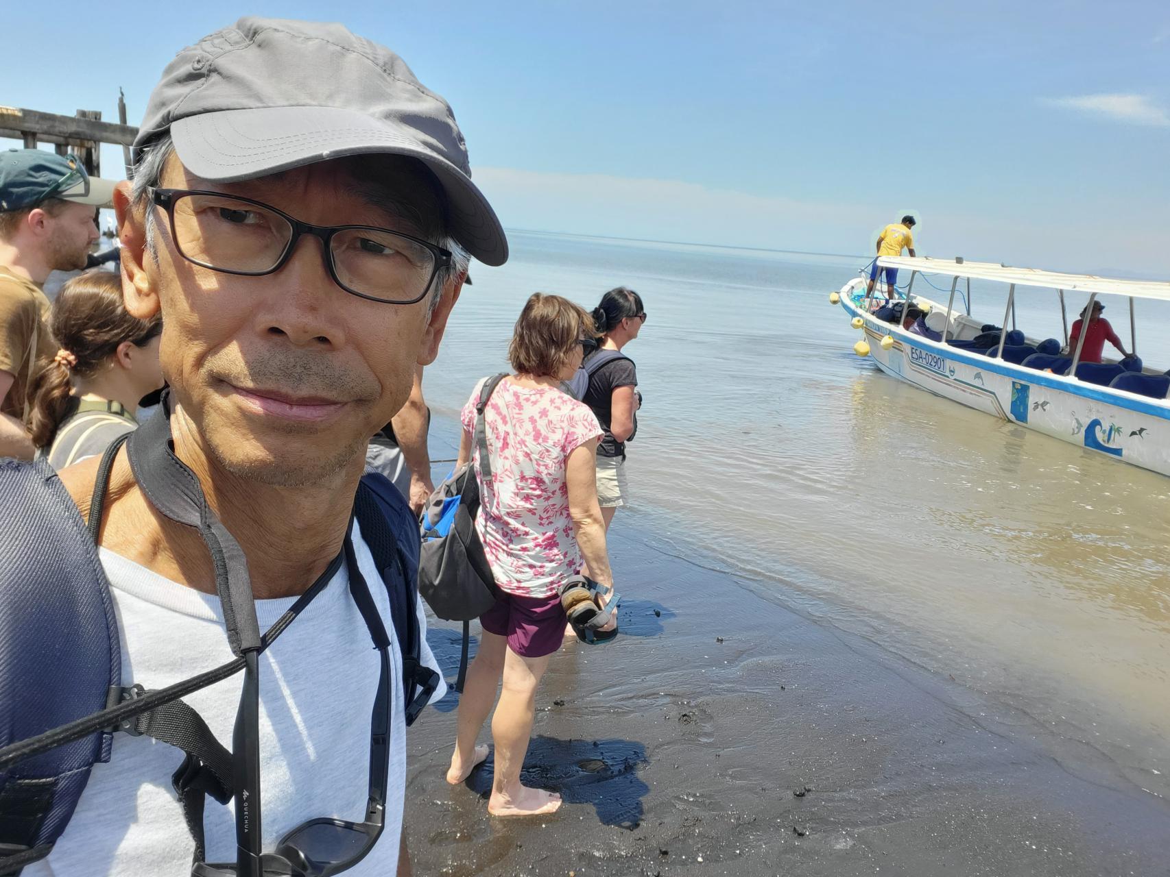 Shoes off and waiting to climb into the boat to La Union, El Salvador