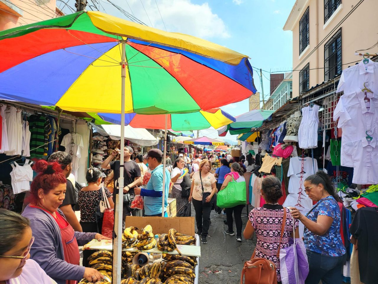 The busy open market streets in San Salvador city center