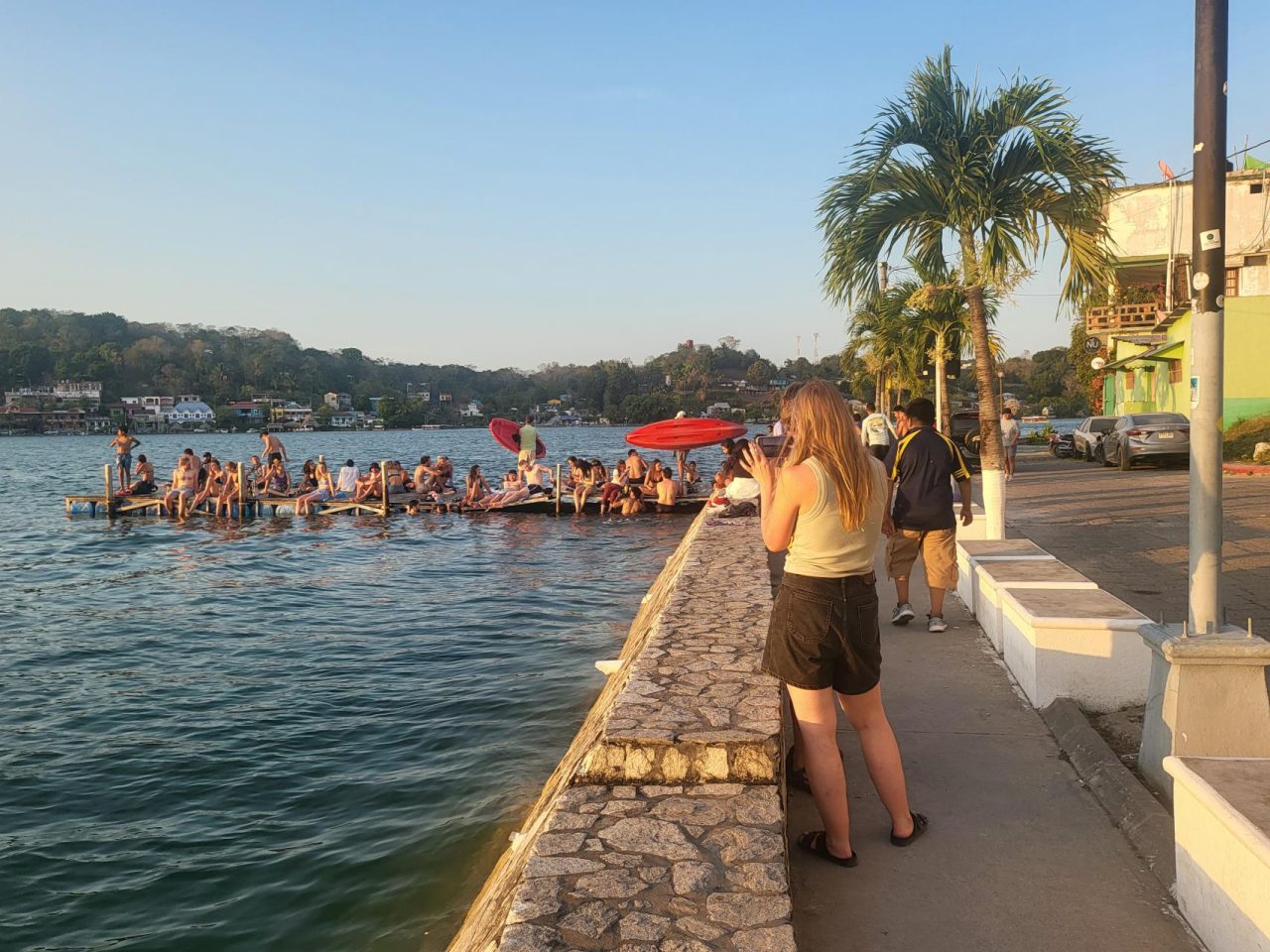 Visitors socialize while keeping cool on a jetty in the lake