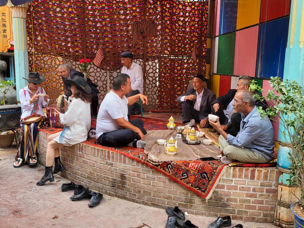 Local Uyghurs having tea at a street corner