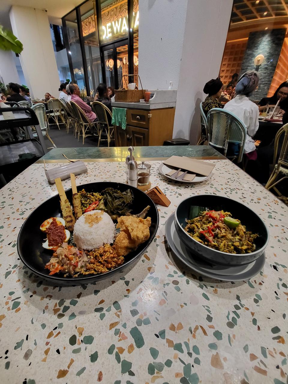 Indonesian rice combo of satay, sambal egg, cooked vegetables and fired chicken